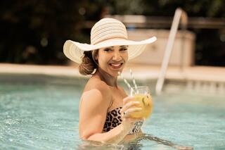 A platter featuring three types of sashimi on a bed of ice, garnished with greens and edible flowers, presenting a vibrant feast.